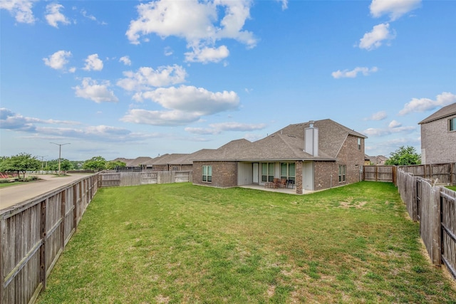 view of yard featuring a patio and a fenced backyard
