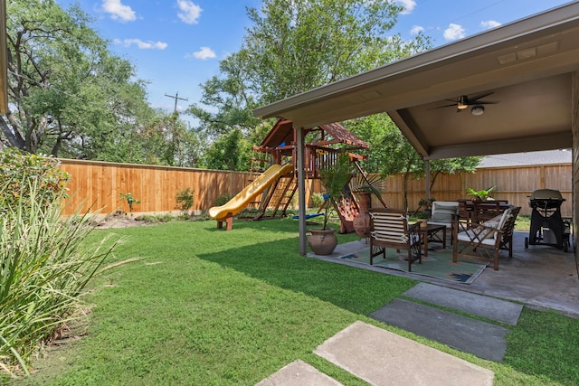 view of yard featuring a fenced backyard, ceiling fan, a playground, and a patio area
