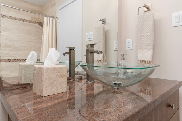 bathroom featuring vanity and curtained shower