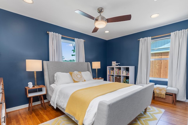 bedroom featuring a ceiling fan, baseboards, recessed lighting, and wood finished floors