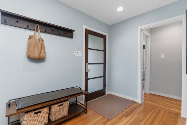 mudroom with recessed lighting, baseboards, and light wood-type flooring
