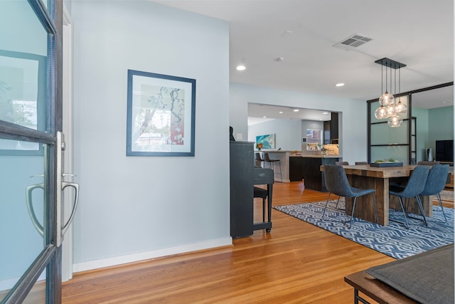 dining room featuring visible vents, recessed lighting, light wood-style floors, and baseboards