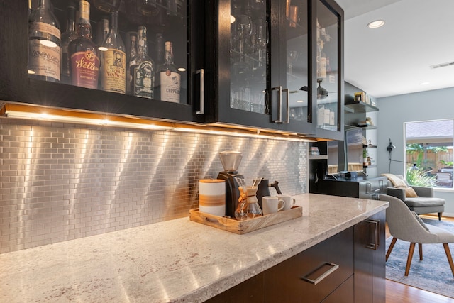 bar featuring backsplash, recessed lighting, wood finished floors, and visible vents