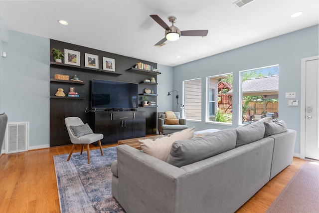 living area featuring visible vents, wood finished floors, baseboards, recessed lighting, and a ceiling fan