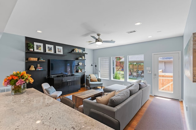 living room with a ceiling fan, visible vents, light wood-style flooring, and recessed lighting