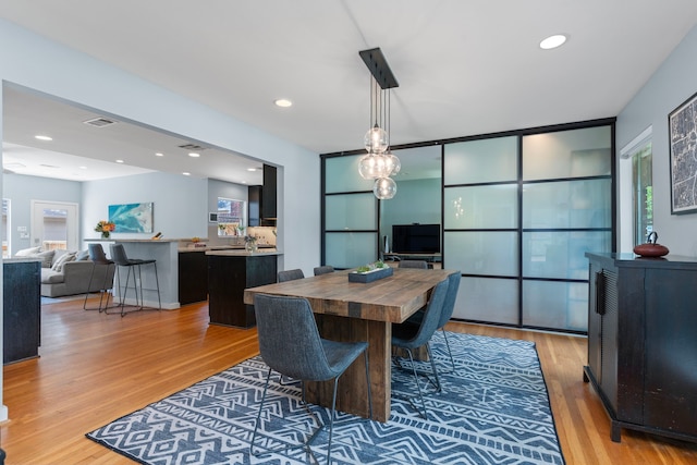 dining space with recessed lighting, visible vents, and light wood-type flooring
