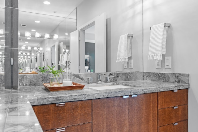 bathroom with vanity, recessed lighting, and visible vents