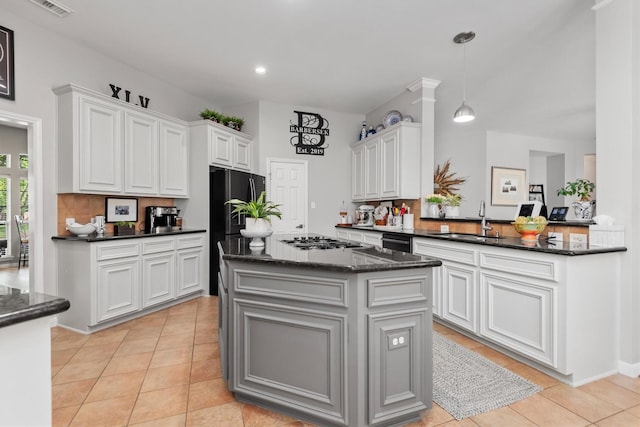 9614 Oconnor Ln, Missouri City, TX 77459 - kitchen featuring a center island, a sink, light tile patterned floors, and black appliances