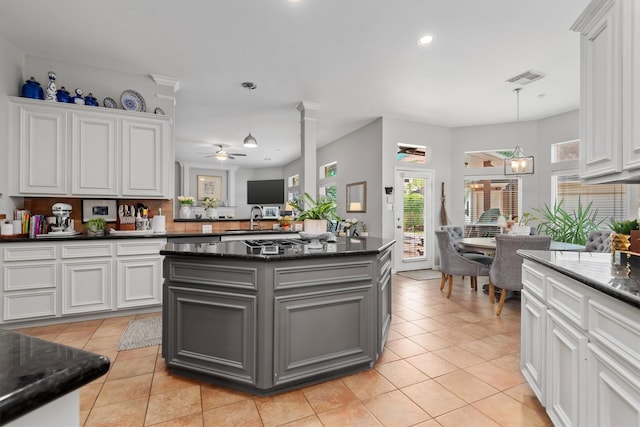 9614 Oconnor Ln, Missouri City, TX 77459 - kitchen with gray cabinetry, white cabinets, a ceiling fan, and visible vents
