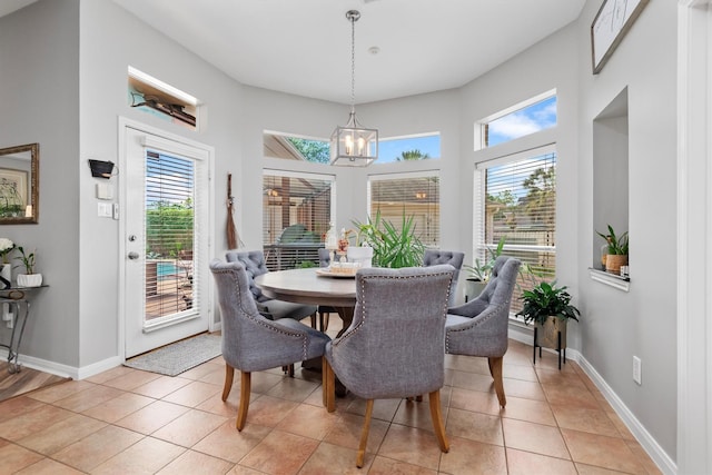 9614 Oconnor Ln, Missouri City, TX 77459 - dining space featuring baseboards, a notable chandelier, plenty of natural light, and light tile patterned floors