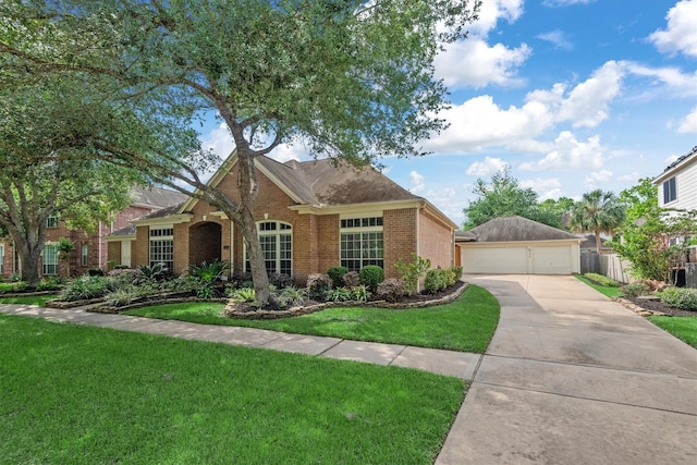 9614 Oconnor Ln, Missouri City, TX 77459 - view of front of house with an outdoor structure, a garage, a front lawn, fence, and brick siding
