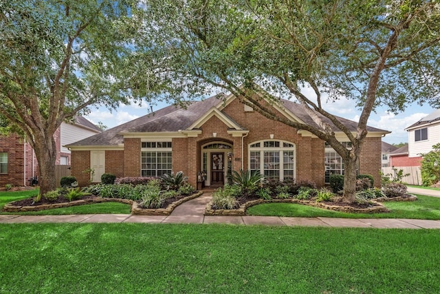 9614 Oconnor Ln, Missouri City, TX 77459 - ranch-style home with brick siding, a shingled roof, and a front lawn