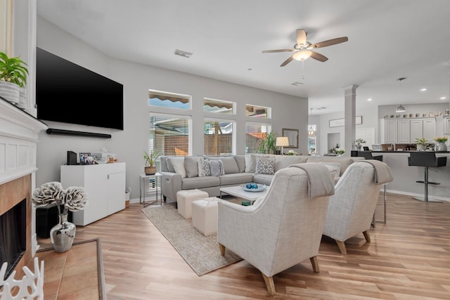 9614 Oconnor Ln, Missouri City, TX 77459 - living room featuring visible vents, a fireplace, ceiling fan, recessed lighting, and light wood-type flooring