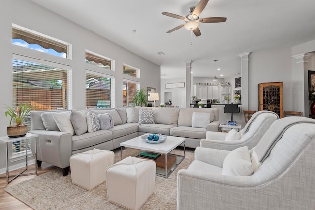 9614 Oconnor Ln, Missouri City, TX 77459 - living area with ornate columns, a ceiling fan, and light wood-type flooring