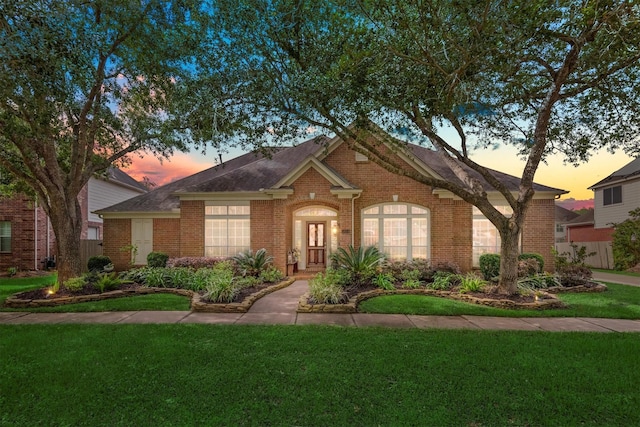 9614 Oconnor Ln, Missouri City, TX 77459 - view of front of property with a lawn, brick siding, and a shingled roof