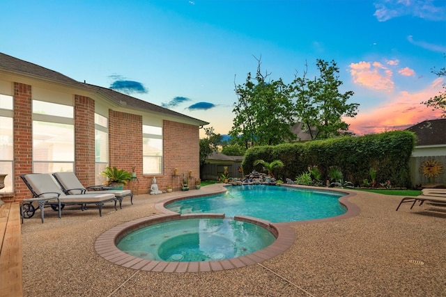 9614 Oconnor Ln, Missouri City, TX 77459 - pool at dusk featuring a patio, a pool with connected hot tub, and a fenced backyard