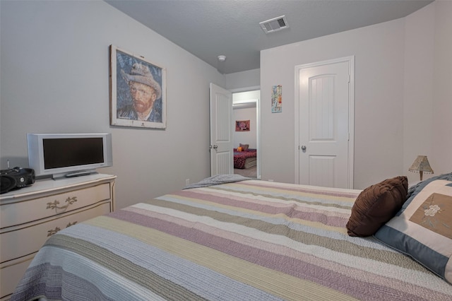 bedroom featuring visible vents
