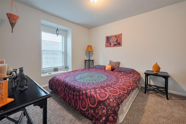 carpeted bedroom featuring baseboards