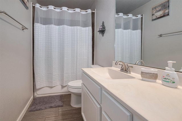 full bathroom featuring shower / bath combo, wood finished floors, vanity, baseboards, and toilet