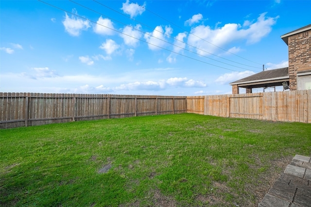 view of yard with a fenced backyard