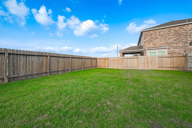 view of yard with a fenced backyard