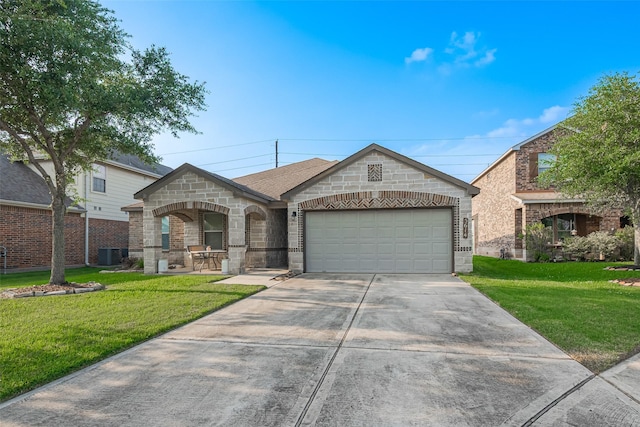 view of front of house with an attached garage, central AC unit, a front lawn, and stone siding