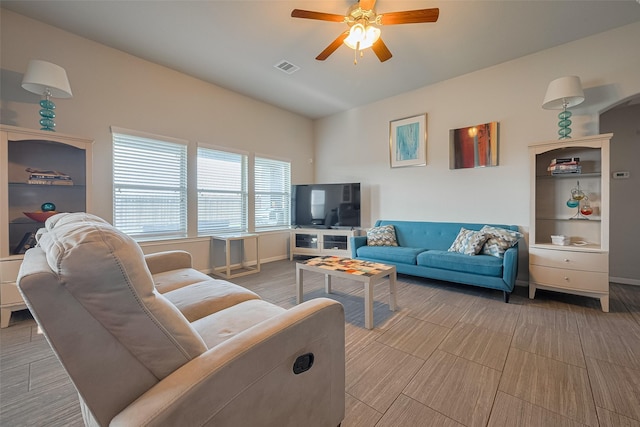 living area featuring visible vents, ceiling fan, and wood finished floors