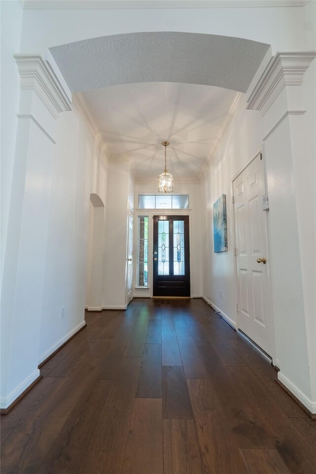 54 N Crossed Birch Pl, The Woodlands, TX 77381 - foyer entrance featuring baseboards, dark wood finished floors, ornamental molding, and an inviting chandelier