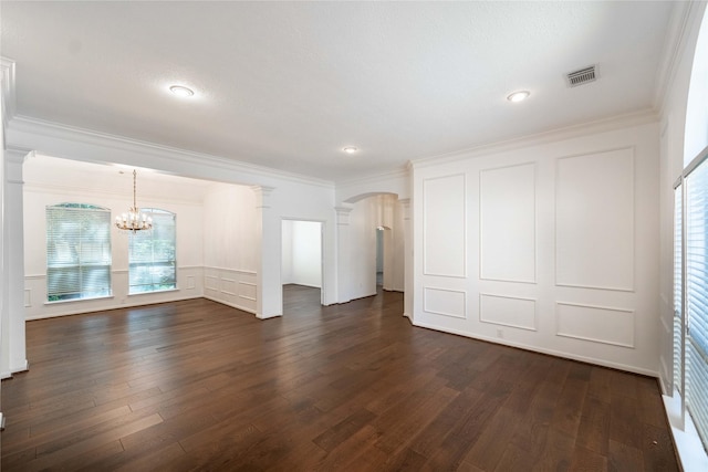 54 N Crossed Birch Pl, The Woodlands, TX 77381 - unfurnished living room featuring visible vents, dark wood finished floors, a chandelier, and decorative columns