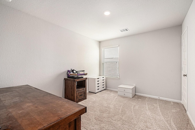 office space featuring visible vents, baseboards, and light colored carpet