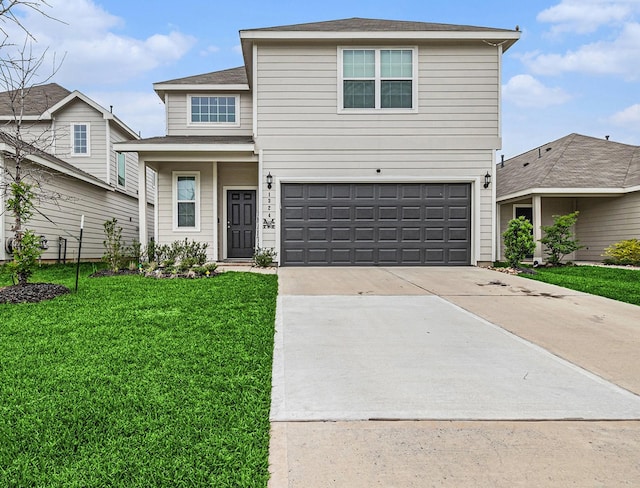 traditional-style house featuring a garage, a front yard, and concrete driveway