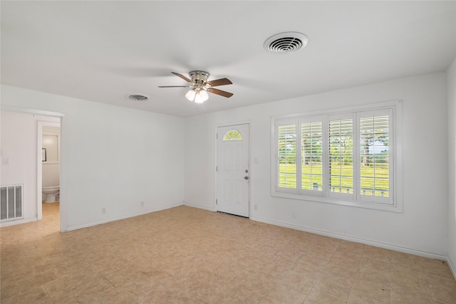 interior space with visible vents, a ceiling fan, and baseboards