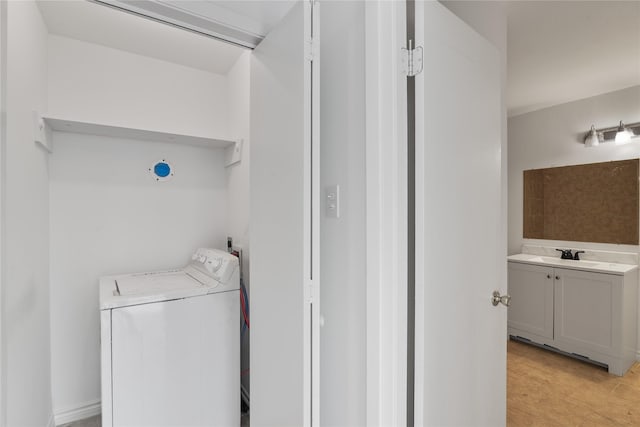 laundry area featuring washer / dryer, laundry area, and a sink