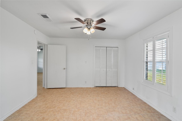 unfurnished bedroom featuring visible vents, baseboards, ceiling fan, and a closet