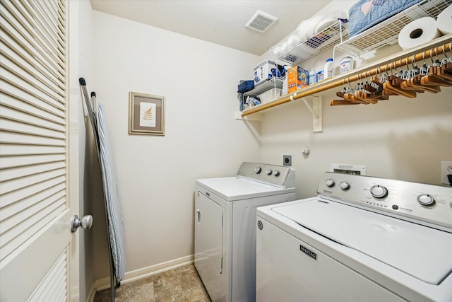 2209 Sabine Dr, Deer Park, TX 77536 - laundry room featuring laundry area, baseboards, stone finish flooring, visible vents, and washer and clothes dryer