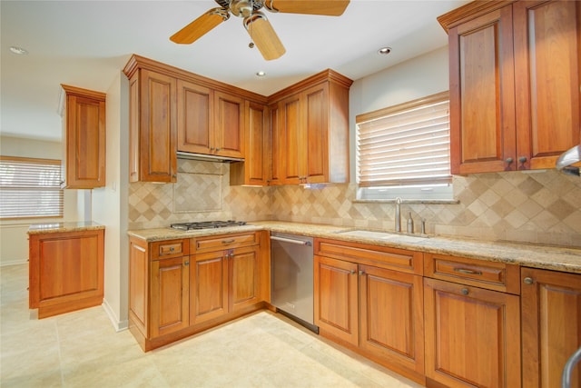5311 Graystone Ln, Houston, TX 77069 - kitchen with appliances with stainless steel finishes, a sink, brown cabinets, light stone counters, and decorative backsplash