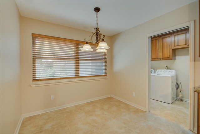 washroom featuring baseboards, cabinet space, independent washer and dryer, and a notable chandelier