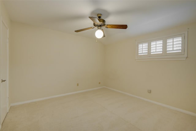 unfurnished room featuring baseboards, ceiling fan, and light colored carpet