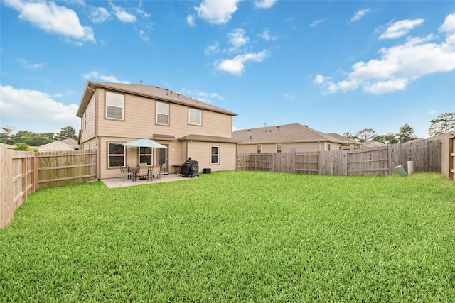 41534 Stampede Stream Dr, Magnolia, TX 77354 - back of house with a lawn, a fenced backyard, and a patio area