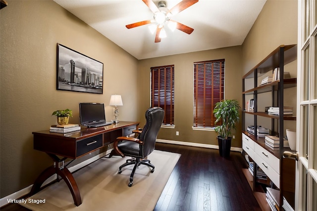 office space with a ceiling fan, baseboards, and dark wood finished floors