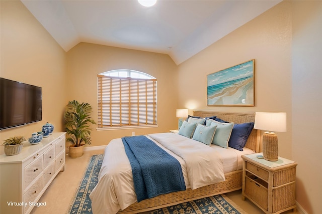 bedroom with baseboards and vaulted ceiling