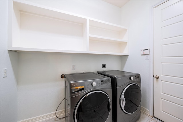 laundry room featuring laundry area, baseboards, and washing machine and dryer