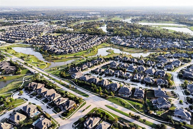 drone / aerial view featuring a residential view and a water view