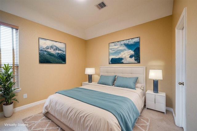 carpeted bedroom featuring visible vents and baseboards