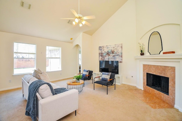 13216 Castlewind Ln, Pearland, TX 77584 - living area with visible vents, arched walkways, high vaulted ceiling, and light carpet