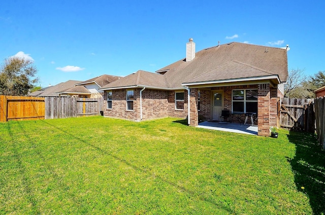 13216 Castlewind Ln, Pearland, TX 77584 - rear view of house with brick siding, a fenced backyard, a chimney, a patio, and a yard