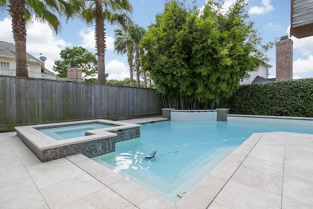 view of pool featuring a fenced backyard and a pool with connected hot tub