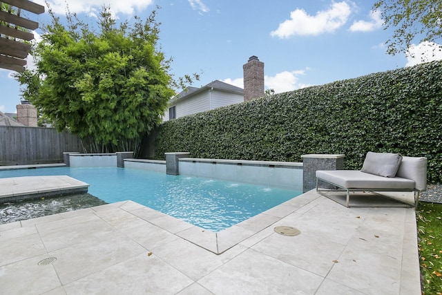 view of swimming pool with a patio, a fenced in pool, and a fenced backyard