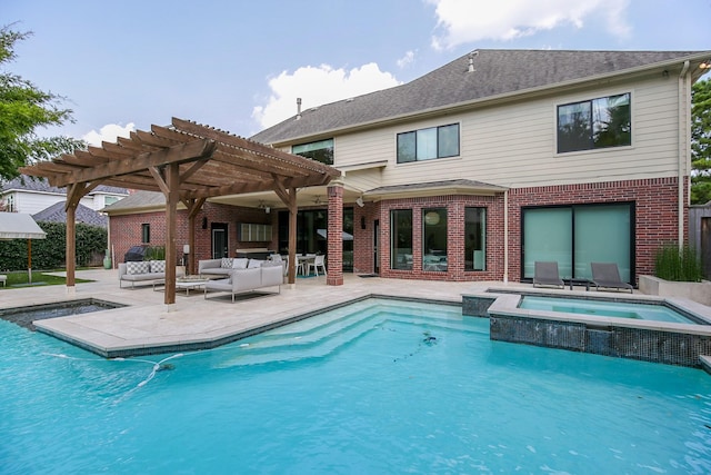 rear view of property with a pergola, a pool with connected hot tub, brick siding, outdoor lounge area, and a patio area