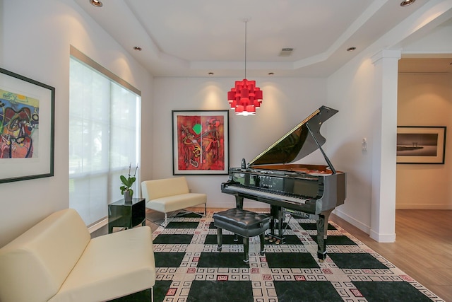 sitting room featuring a raised ceiling, recessed lighting, baseboards, wood finished floors, and visible vents